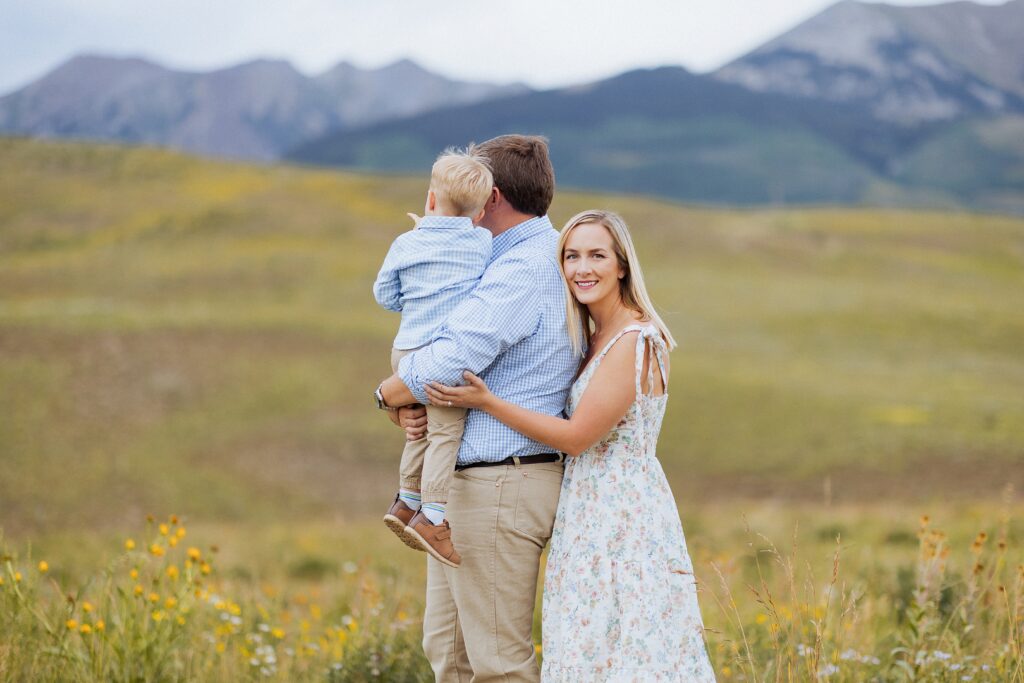 candid family moment in wildflowers during summer in Mt Crested Butte Colorado