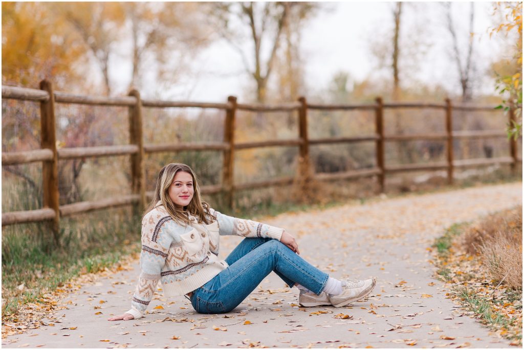 Senior girl sitting on fall path for session
