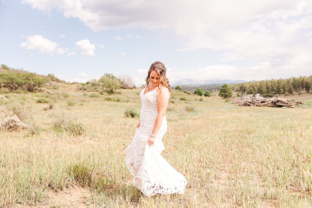 Bride swishing dress in field | Montrose Wedding Photographer 
