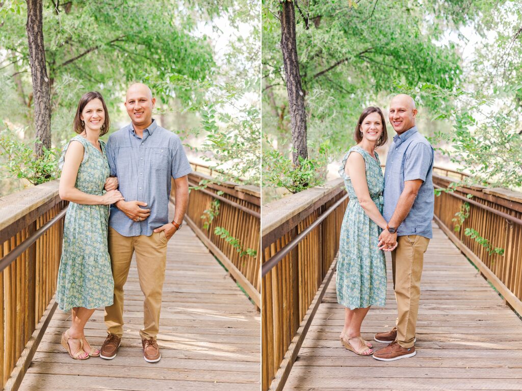 Couple in neutral tones and blue pose on bridge for photo