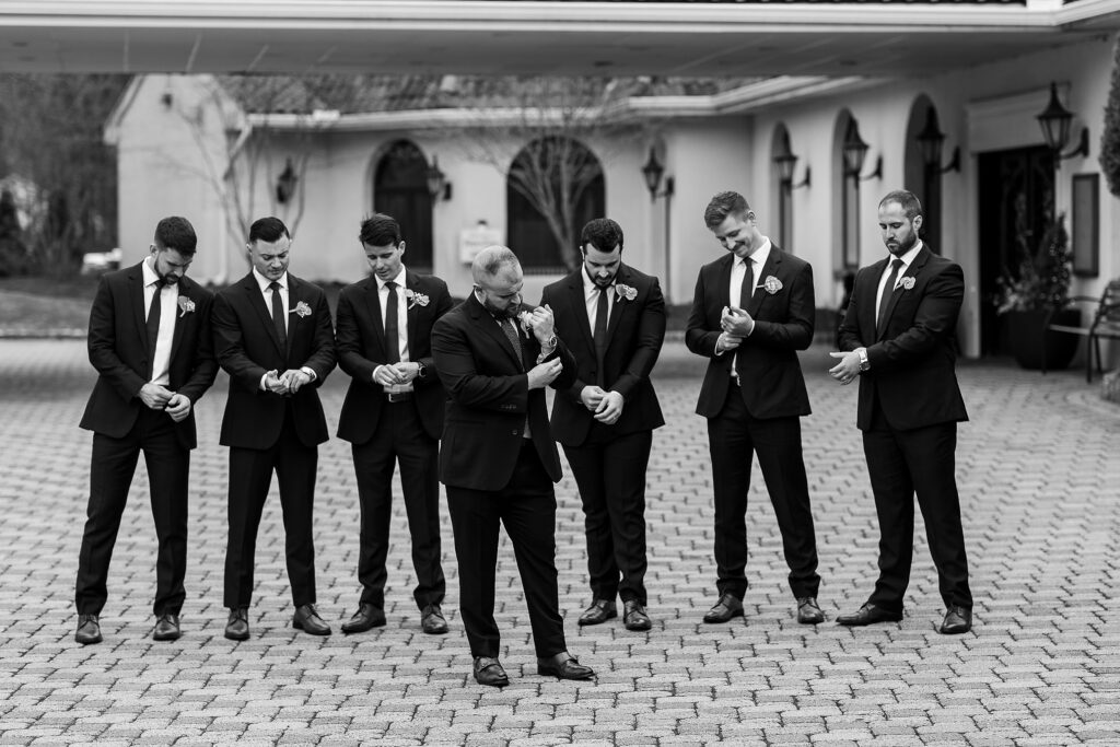 black and white groomsmen images
groomsmen photos
groomsmen poses
groomsmen fixing cuffs on suits
perona farms nj wedding venue 
new jersey wedding photographer 