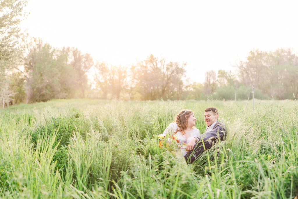 Bride and groom sitting images
sunset in a field photos
laughing bride and groom
wedding day photos
