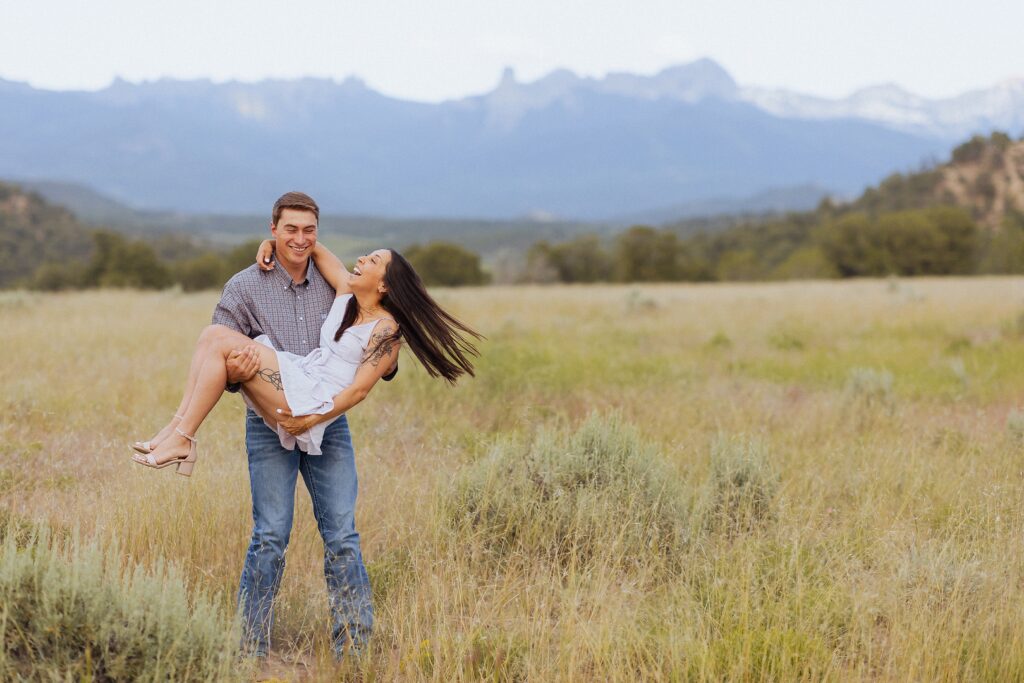 fun engagement photos with couple in San Juan Mountains

candid laughing moments during Colorado mountain engagement session

playful engagement photos in mountain setting