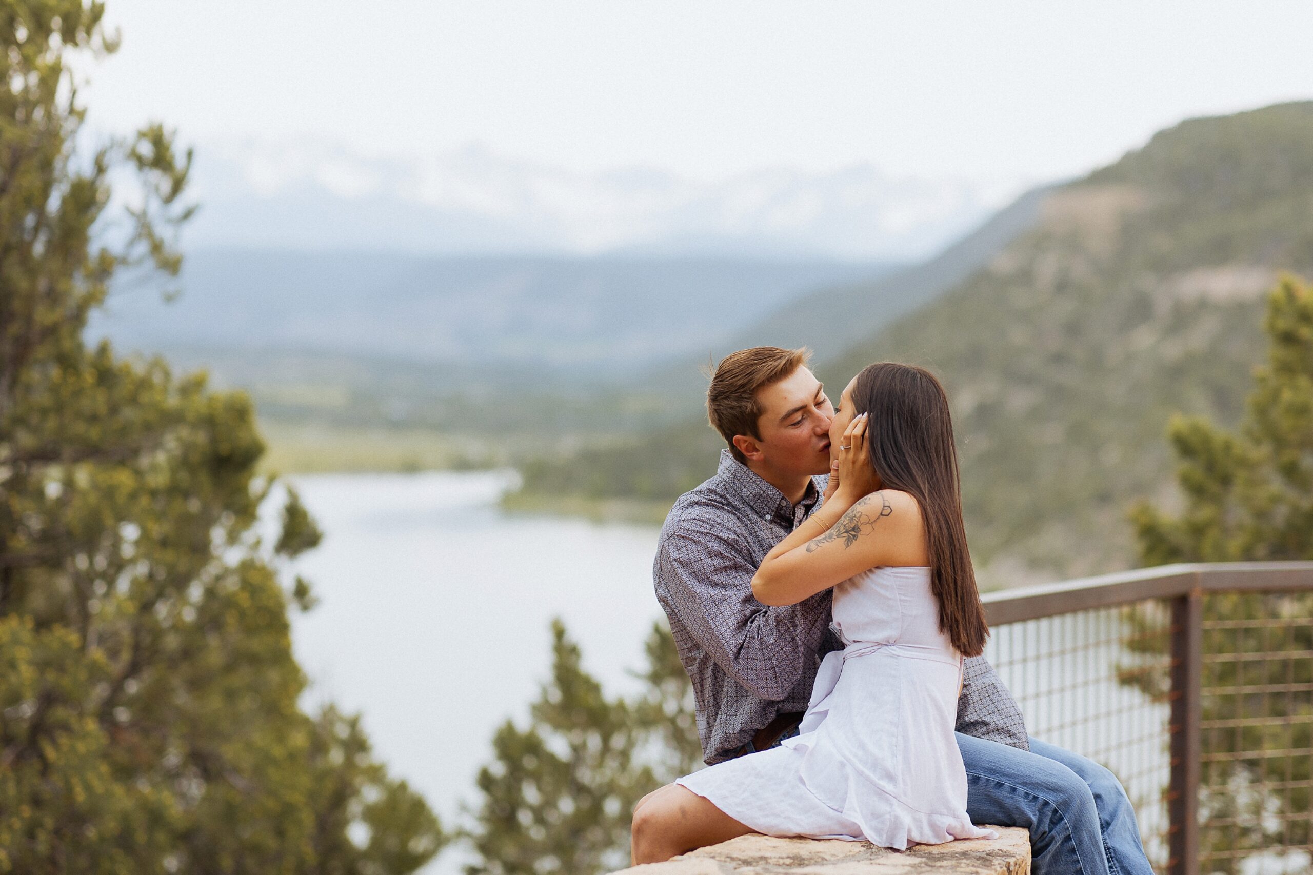 San Juan Mountain engagement photos with couple overlooking lake at sunset