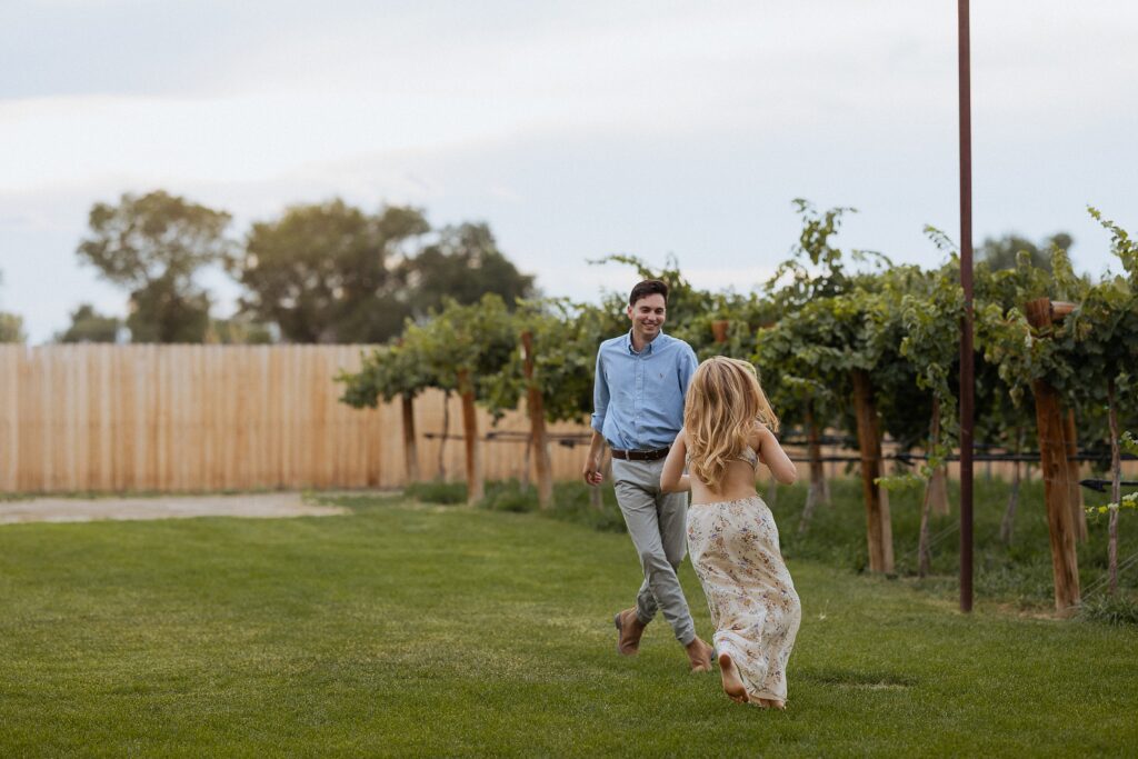 couple laughing during Palisade vineyard engagement session

fun candid engagement photos at Clark and Co Distilling

playful couple moments in vineyard engagement session