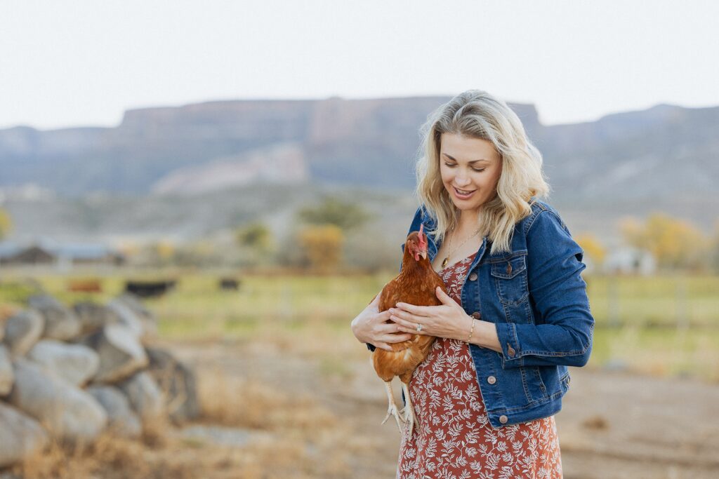 Golden hour family session in Fruita Colorado with warm desert light mom with her chicken